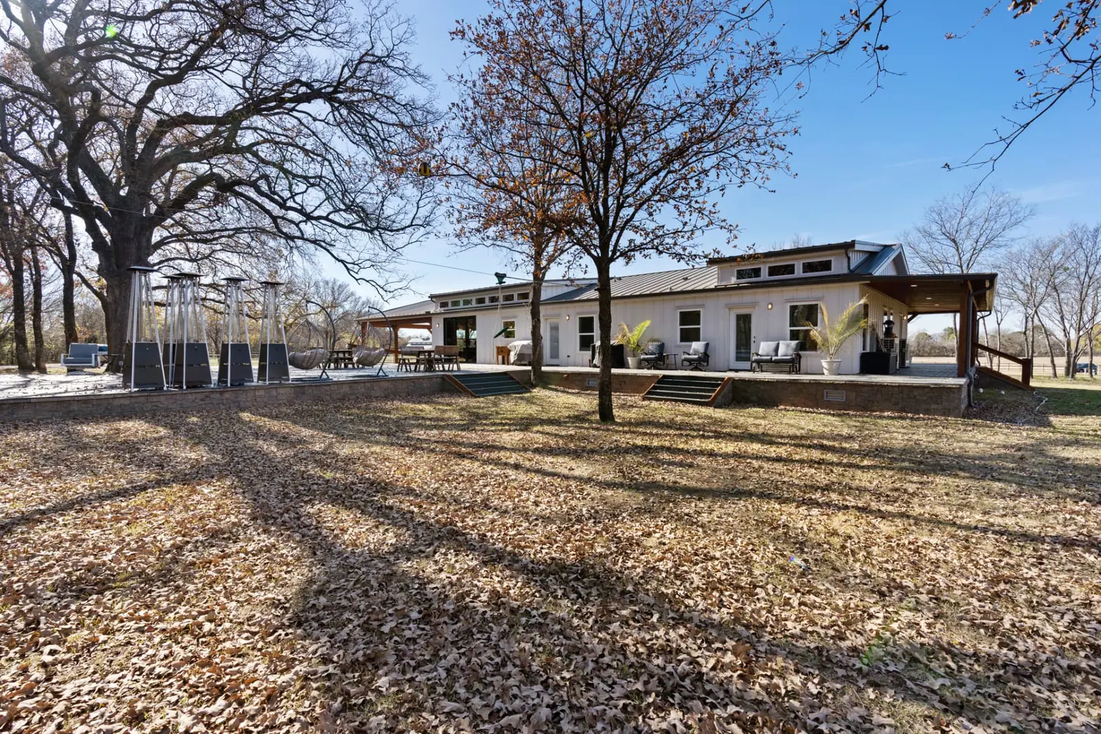 Rear exterior with wraparound deck and patio heaters