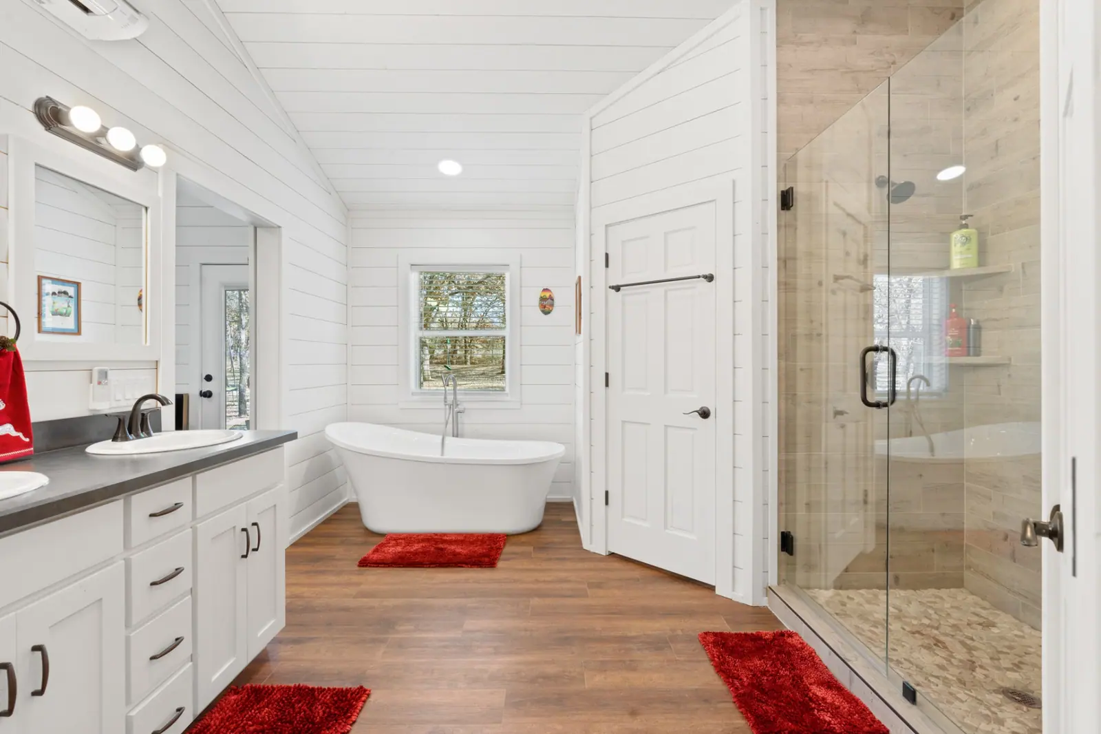 Primary bath with freestanding soaking tub, double vanity and tiled walk-in shower