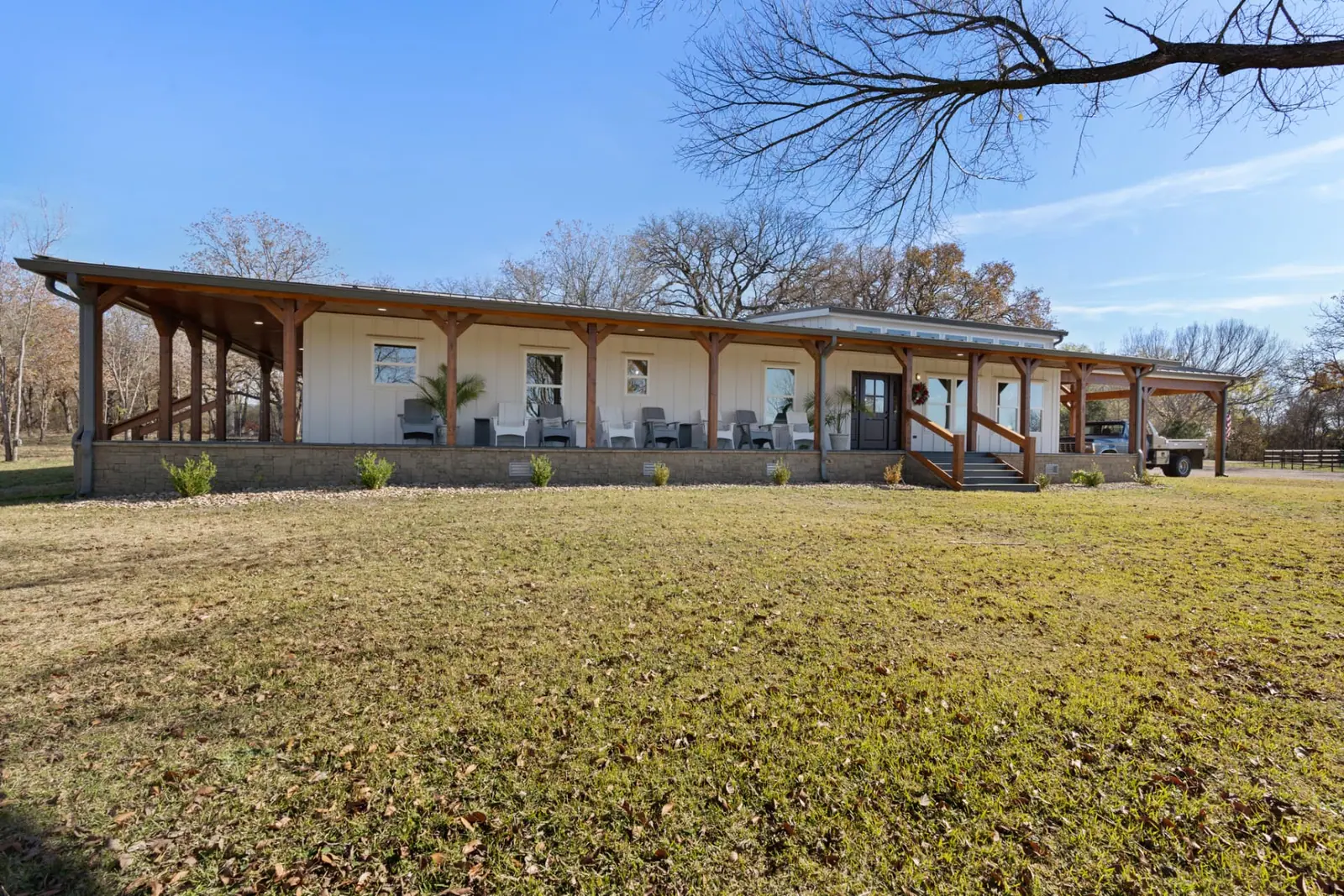 Front exterior with full-length covered porch and timber posts