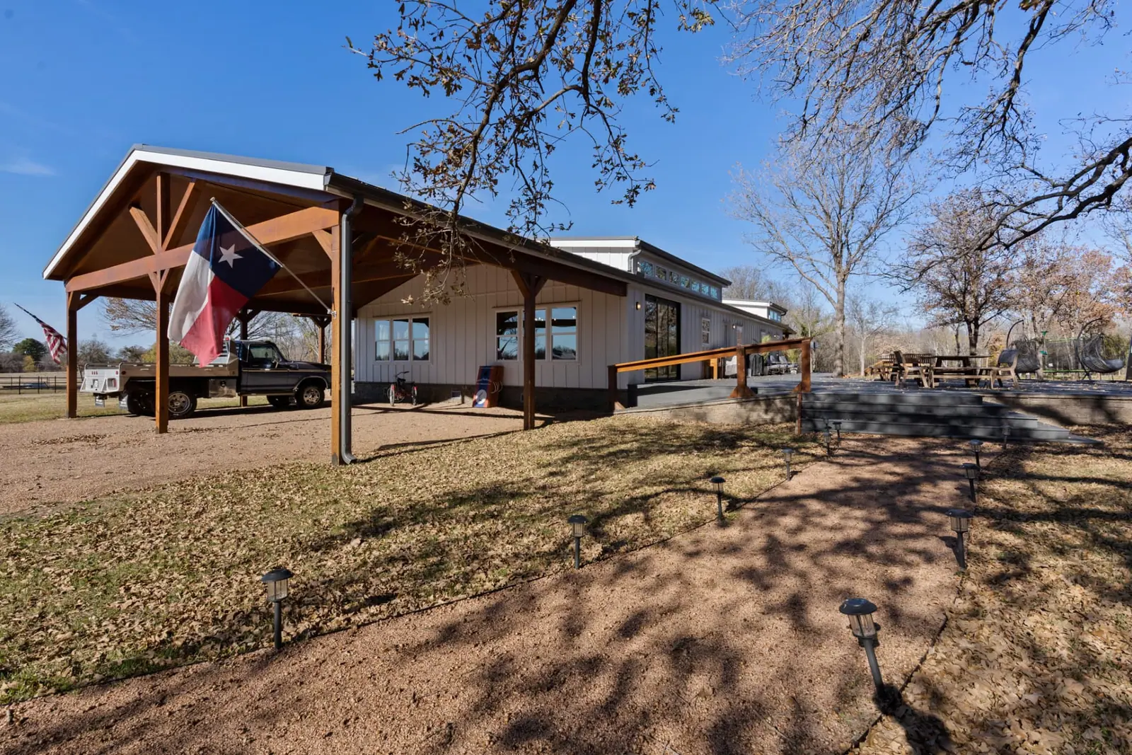 Exterior side view with covered carport and Texas flag