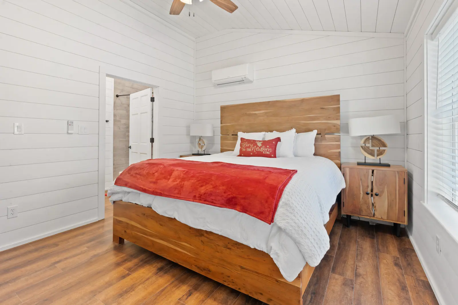 Guest bedroom with live-edge wood bed frame and vaulted shiplap ceiling