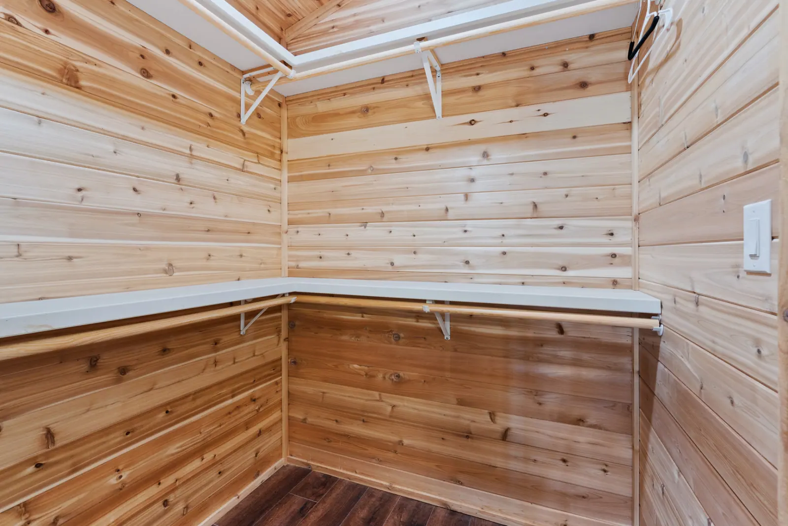 Cedar-lined walk-in closet with shelving and hanging rods