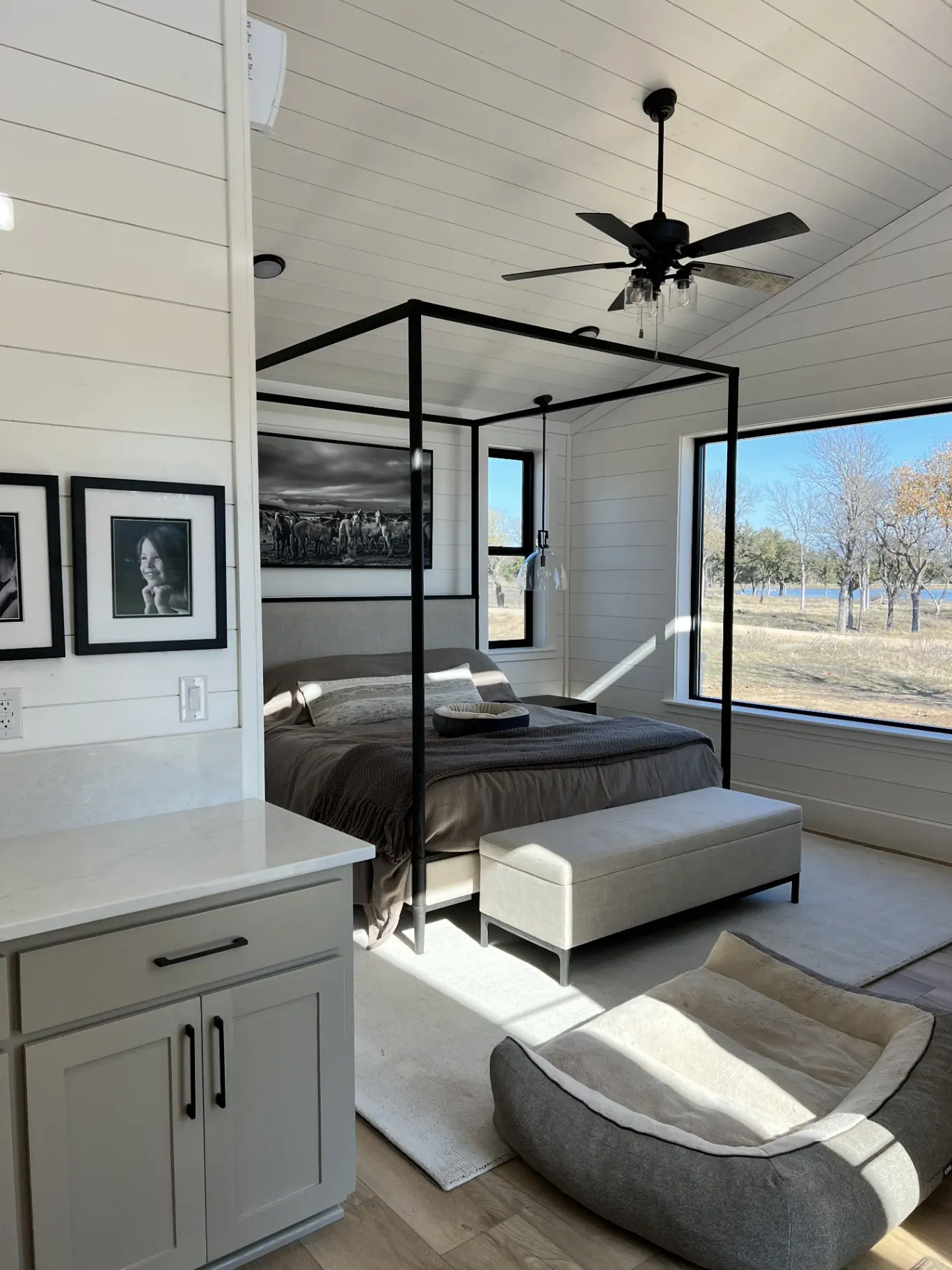 Primary bedroom with iron canopy bed and pasture views
