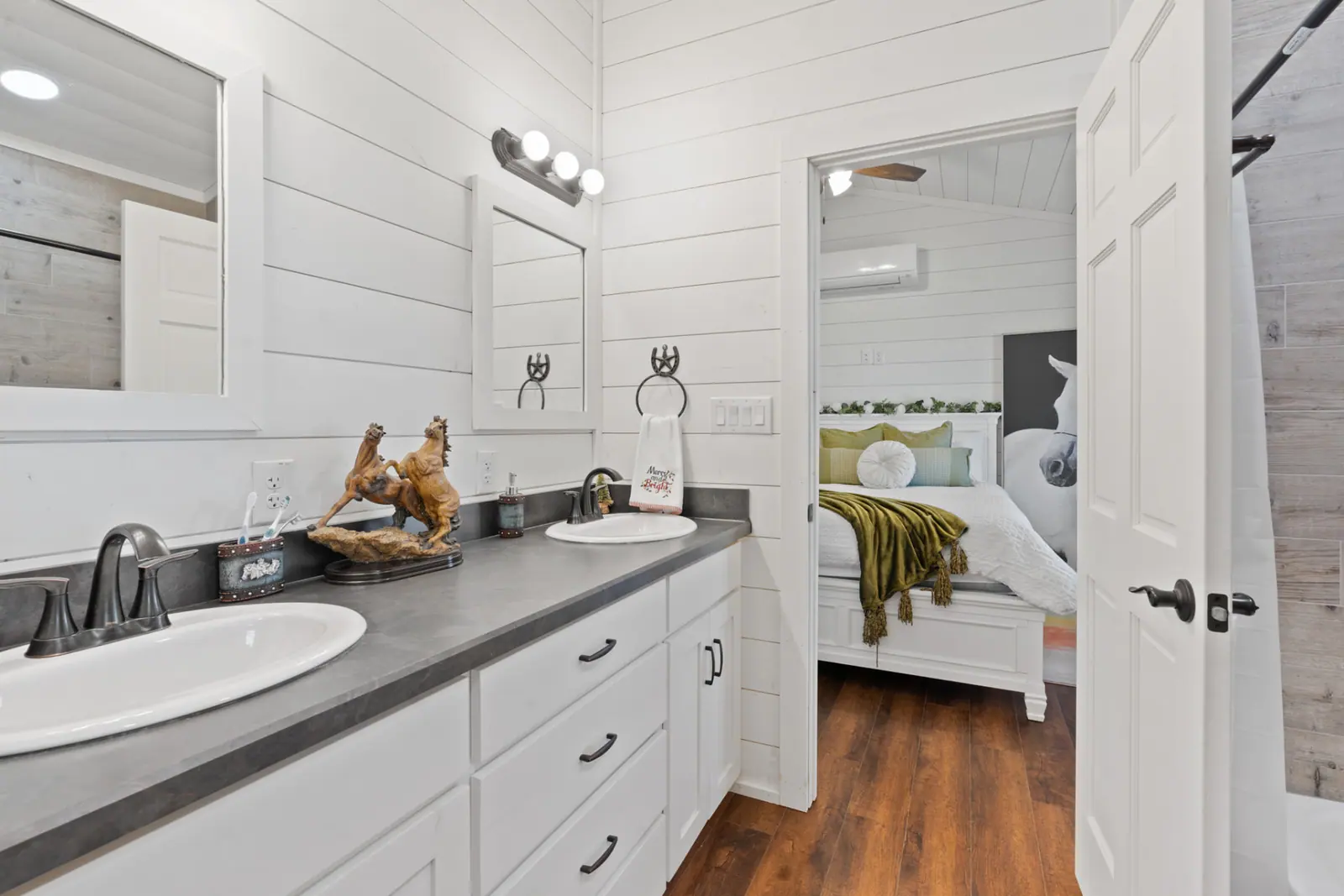Ensuite bath with double sinks, framed mirrors and tiled walk-in shower